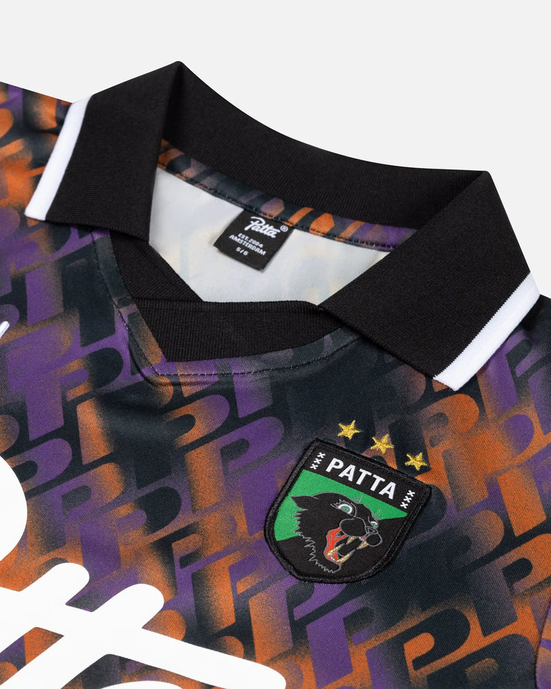 Close-up of the Patta All Over P Football Jersey in Pansy featuring the collar and woven crest badge.